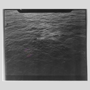 RAF Reconnaissance Photograph – Wrecked LCM with Cylindrical Cargo (WWII Maritime Supply Craft)