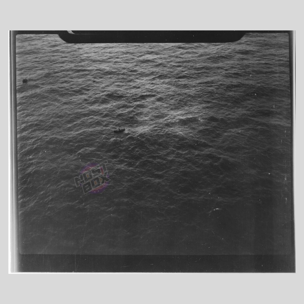 RAF Reconnaissance Photograph – Wrecked LCM with Cylindrical Cargo (WWII Maritime Supply Craft)