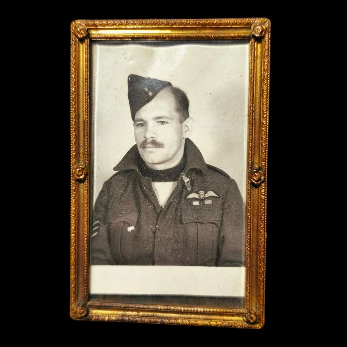 Original WWII portrait photograph of RAF navigator J.C. Elphick in uniform with aircrew brevet wings.